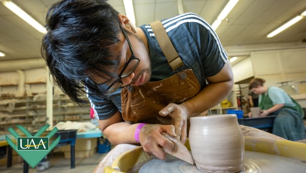 UAA student works the potter's wheel.
