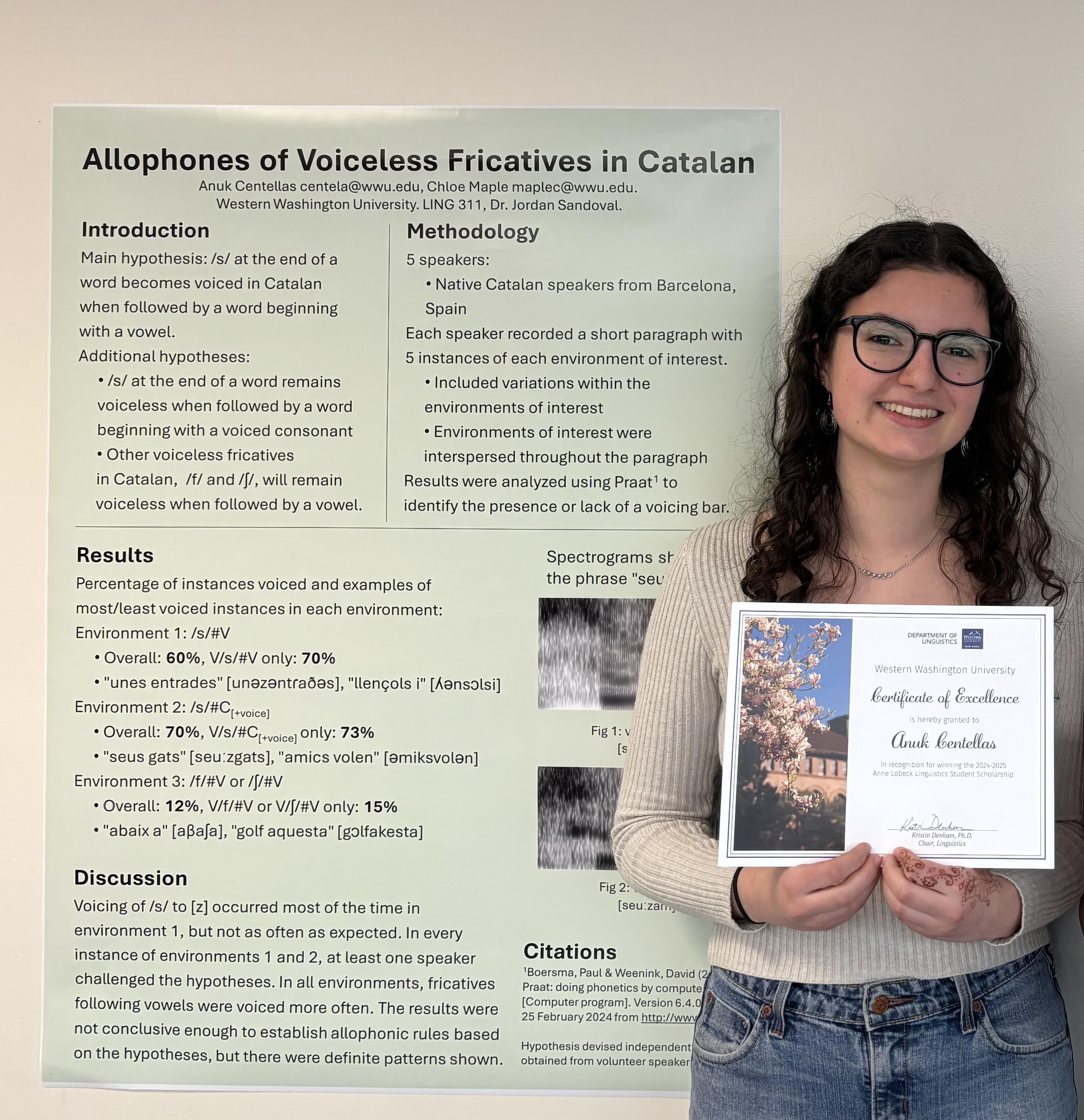Anuk Centellas standing beside an academic poster and holding a scholarship certificate.