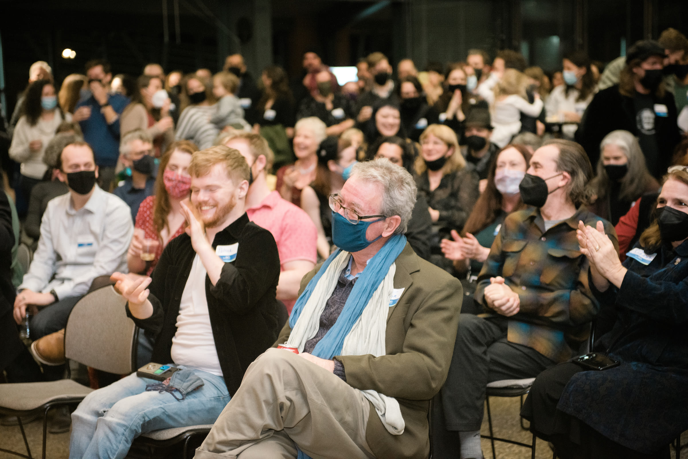 jim lortz sits among a crowd of people at his retirement celebration