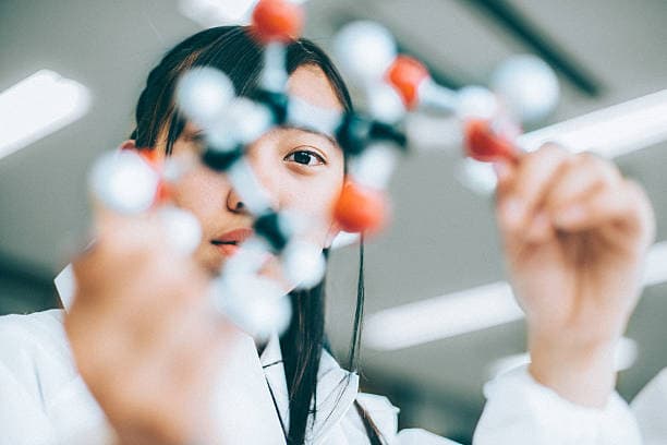 Teenage Student in Chemistry Lab Japanese High School Girl holding a glucose molecular model in the chemistry lab chemistry student stock pictures, royalty-free photos & images