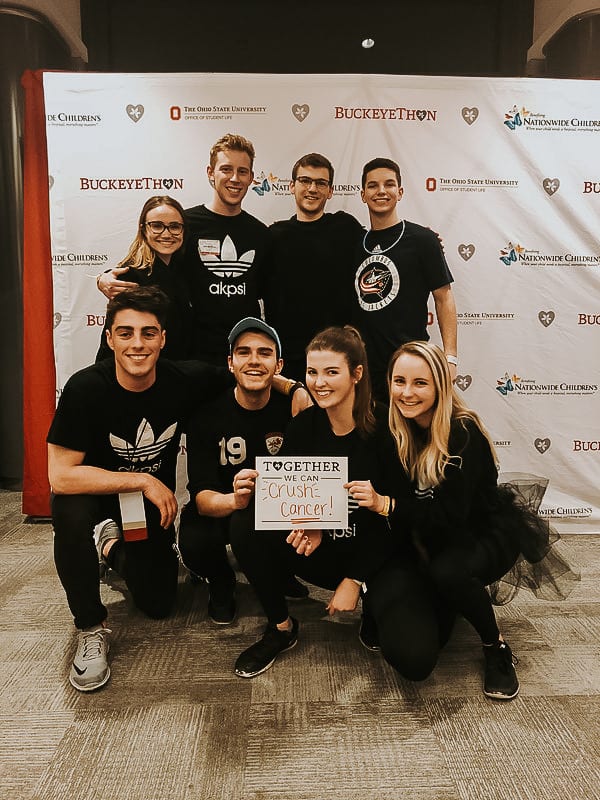 Eight members participate in Buckeyethon. Two hold a sign that reads 'Together we can crush cancer'