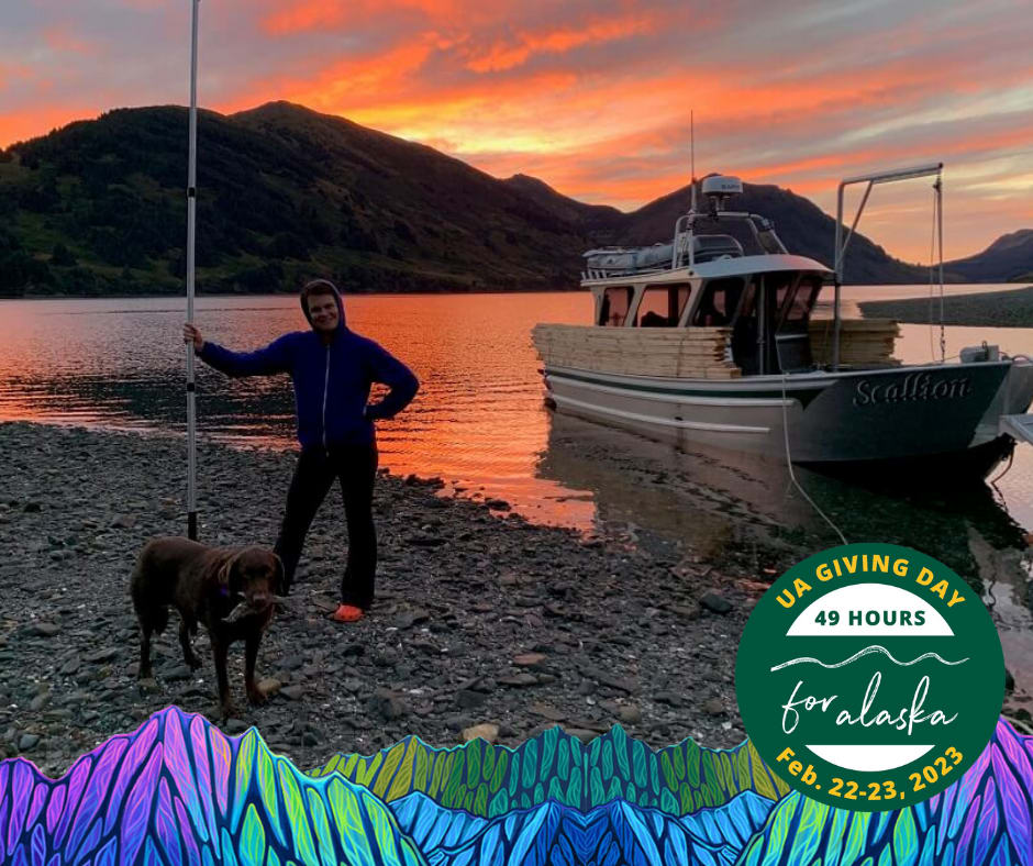 Meghan Kelly, faculty member at Kodiak, standing in front of a boat, lake and beautiful sunset and mountains. Brown lab dog in front of her