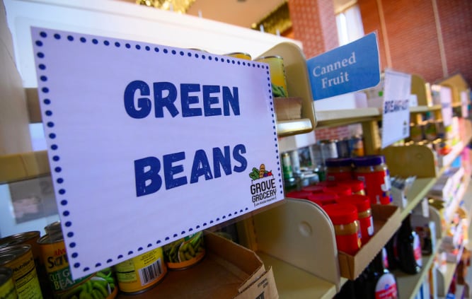 Shelves of Grove Grocery with sign that says green beans