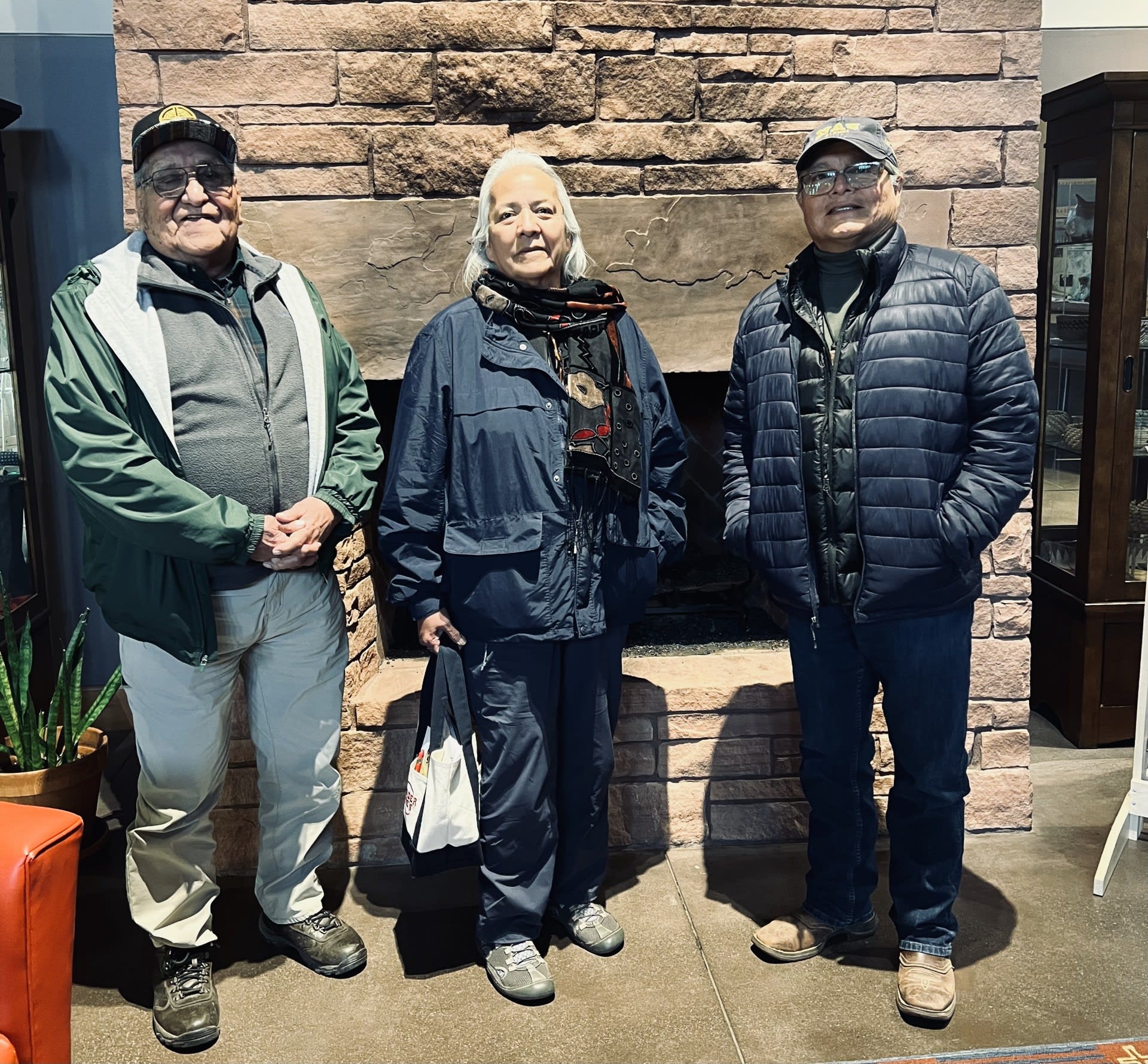 A group of people standing in front of a stone fireplace

AI-generated content may be incorrect.