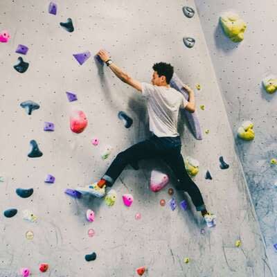 A person climbing a rock wall

Description automatically generated