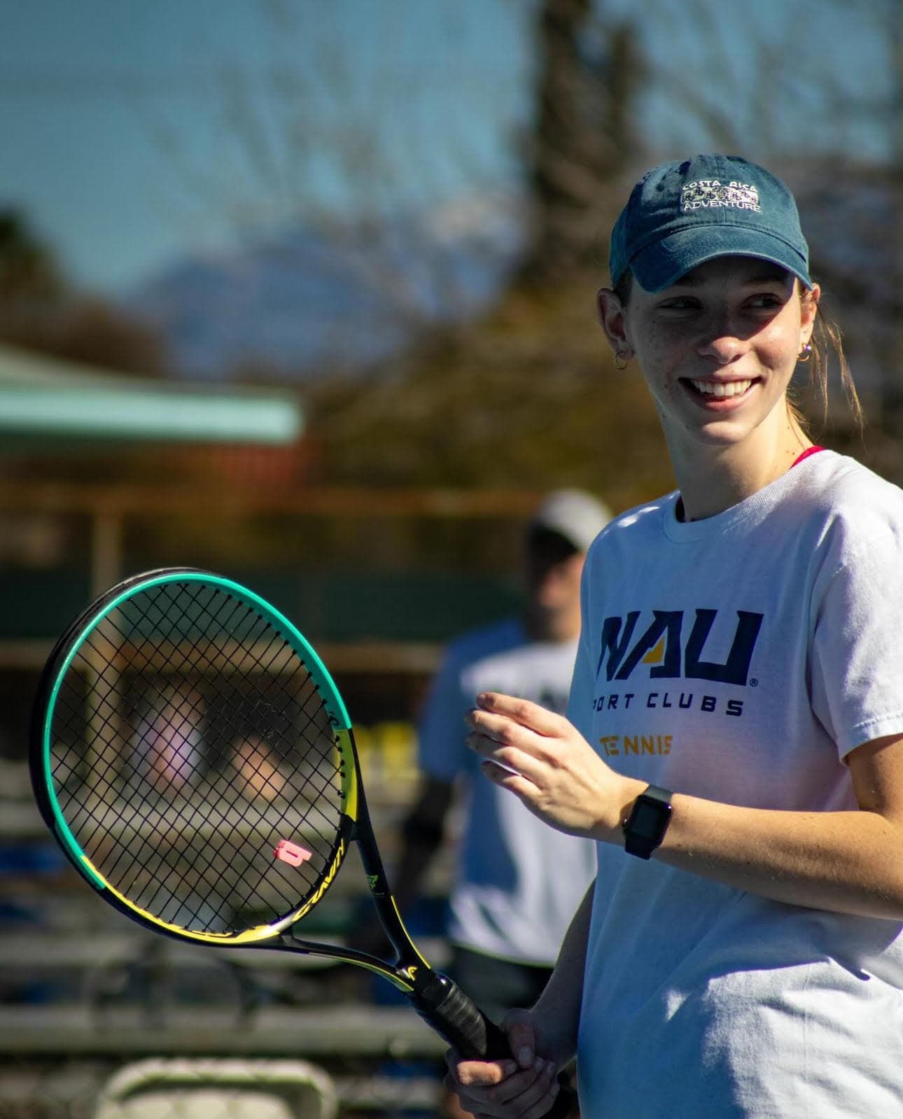Tennis player on court smiling