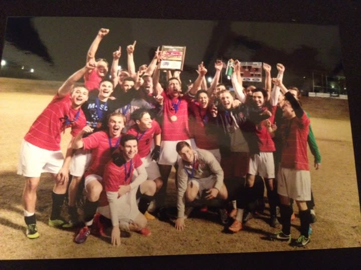 Group of soccer players celebrating their overtime win