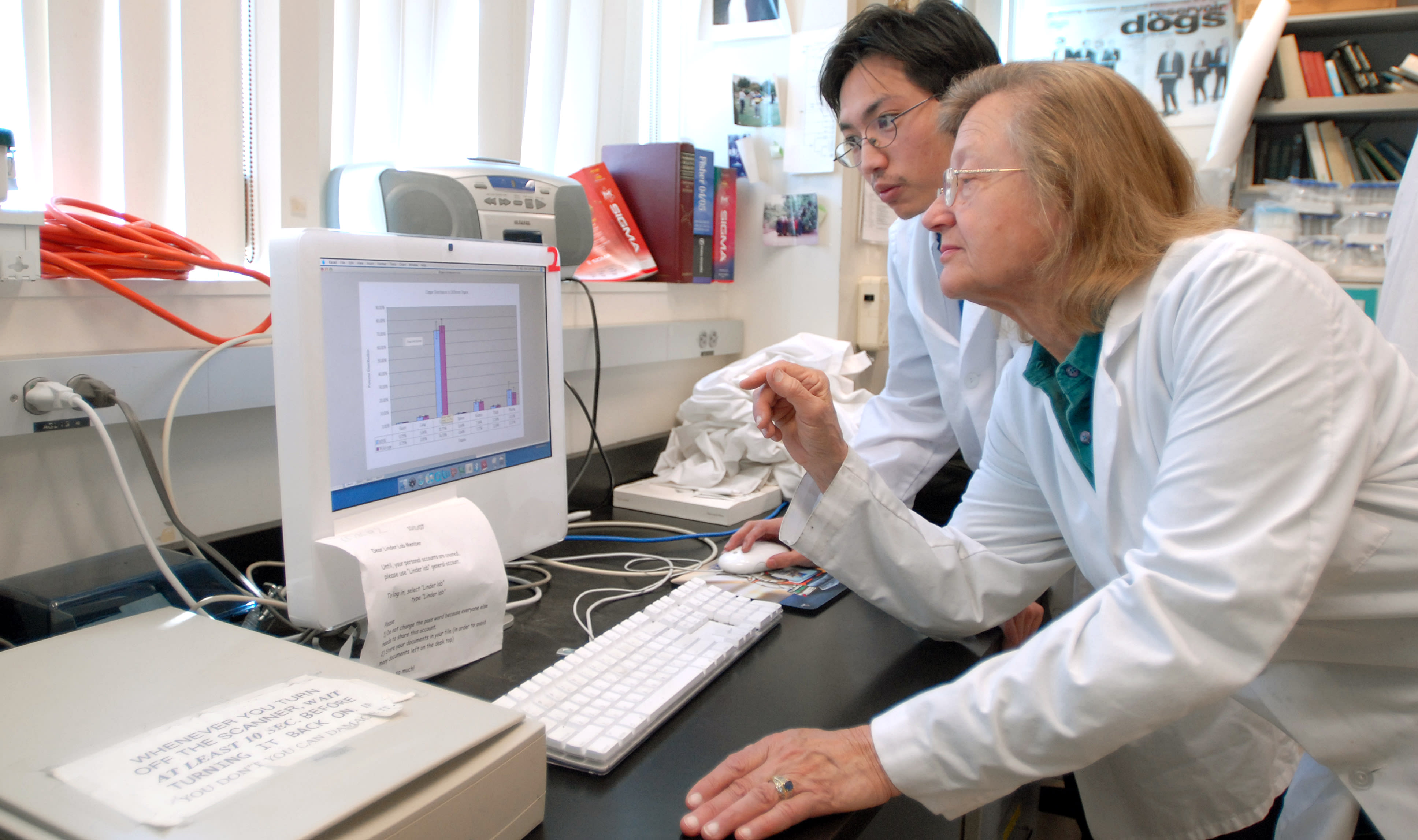 Maria in lab with student