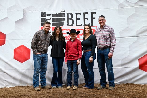 Five members of the Bailey family. They stand before the Beef Expo backdrop