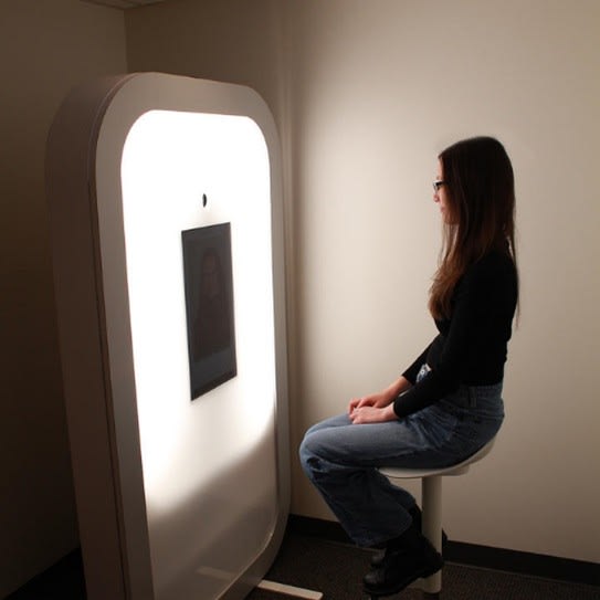 Student posing for a professional headshot at the Iris Photo Booth.