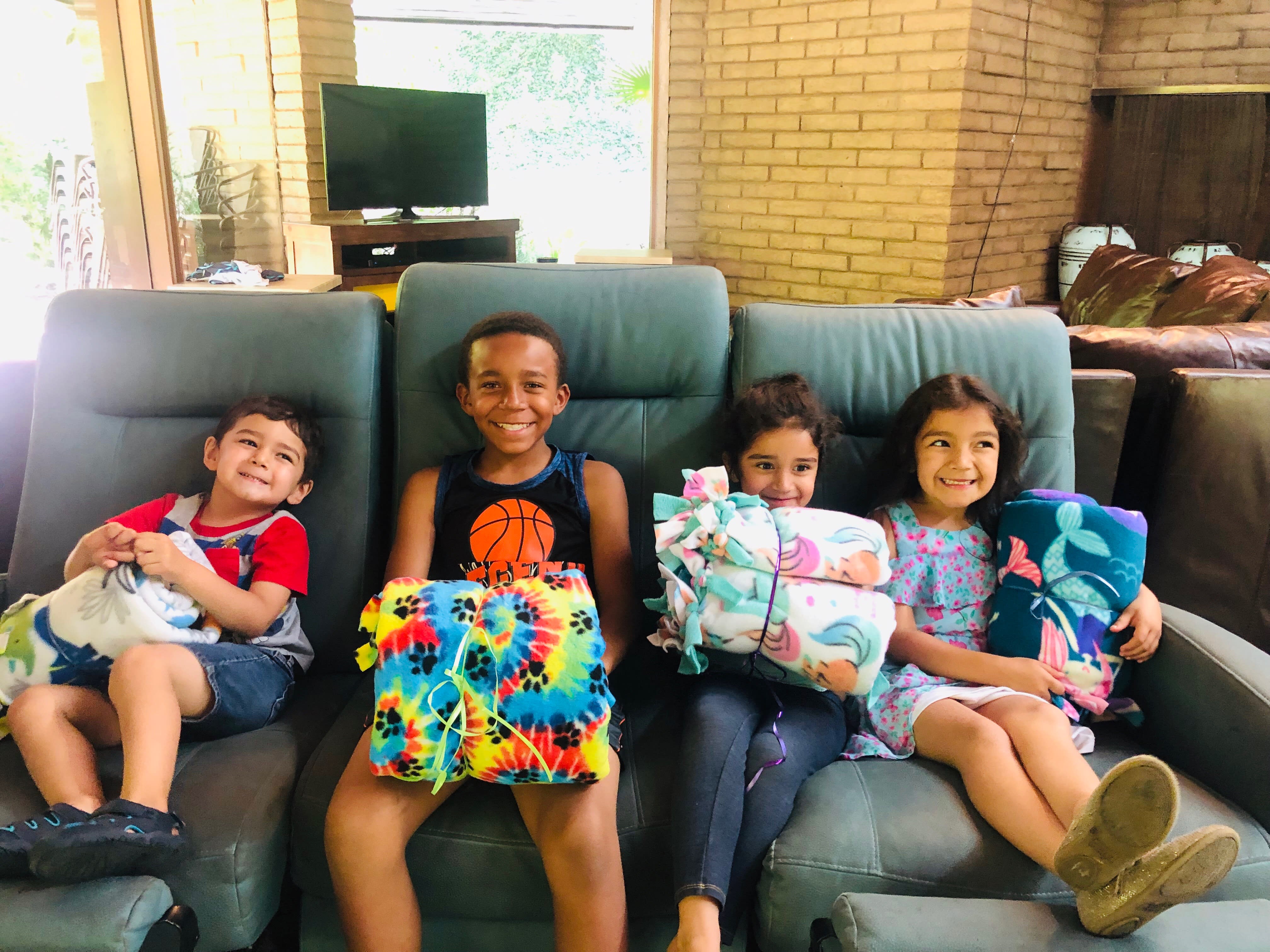 Photo of Hope Gardens children enjoying their blankets