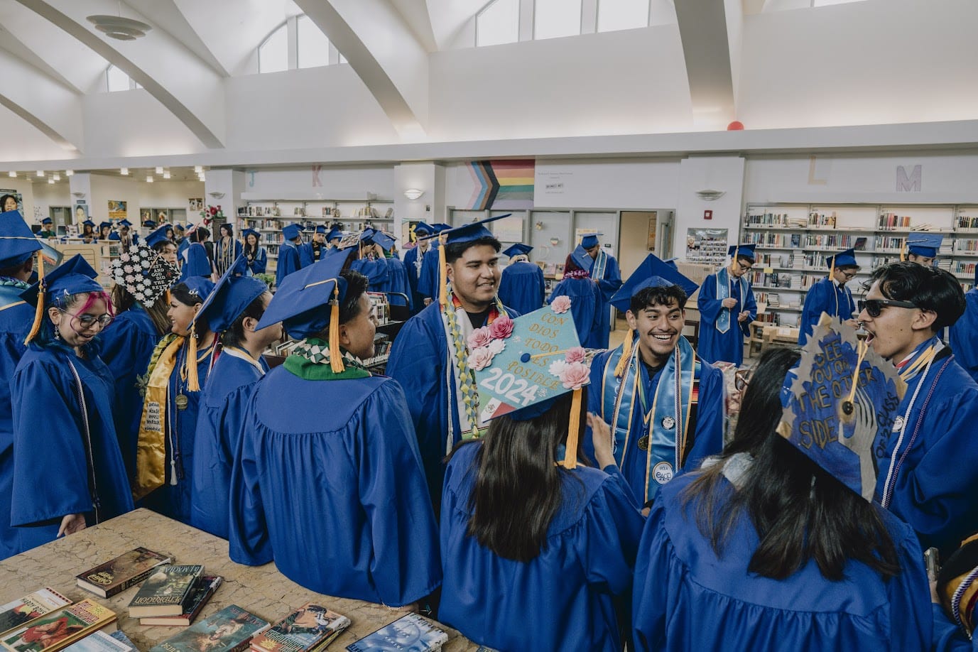 A group of people in blue graduation gowns and caps

Description automatically generated