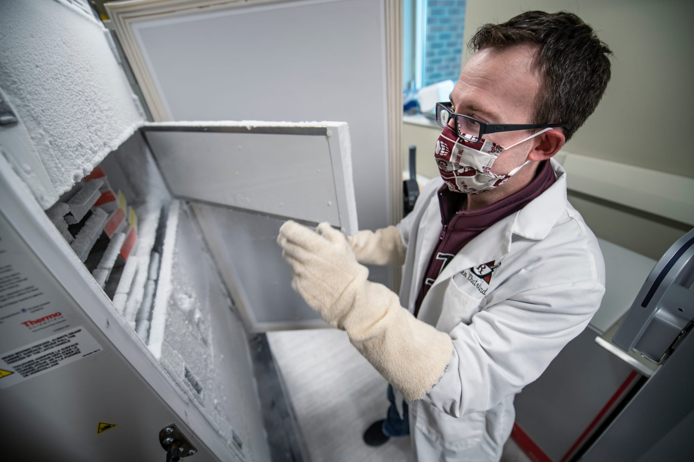 Curry pharmacy manager Ken Chatriand prepares one of three freezers for storing Covid vaccines at the University of Montana.