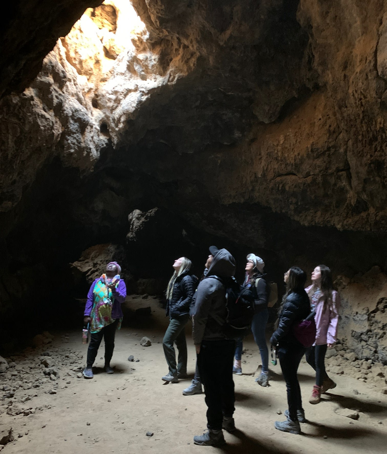 Environmental Studies students exploring a lava tunnel in the Mojave National Preserve, 2021, during their visit to the CSU Desert Studies Center