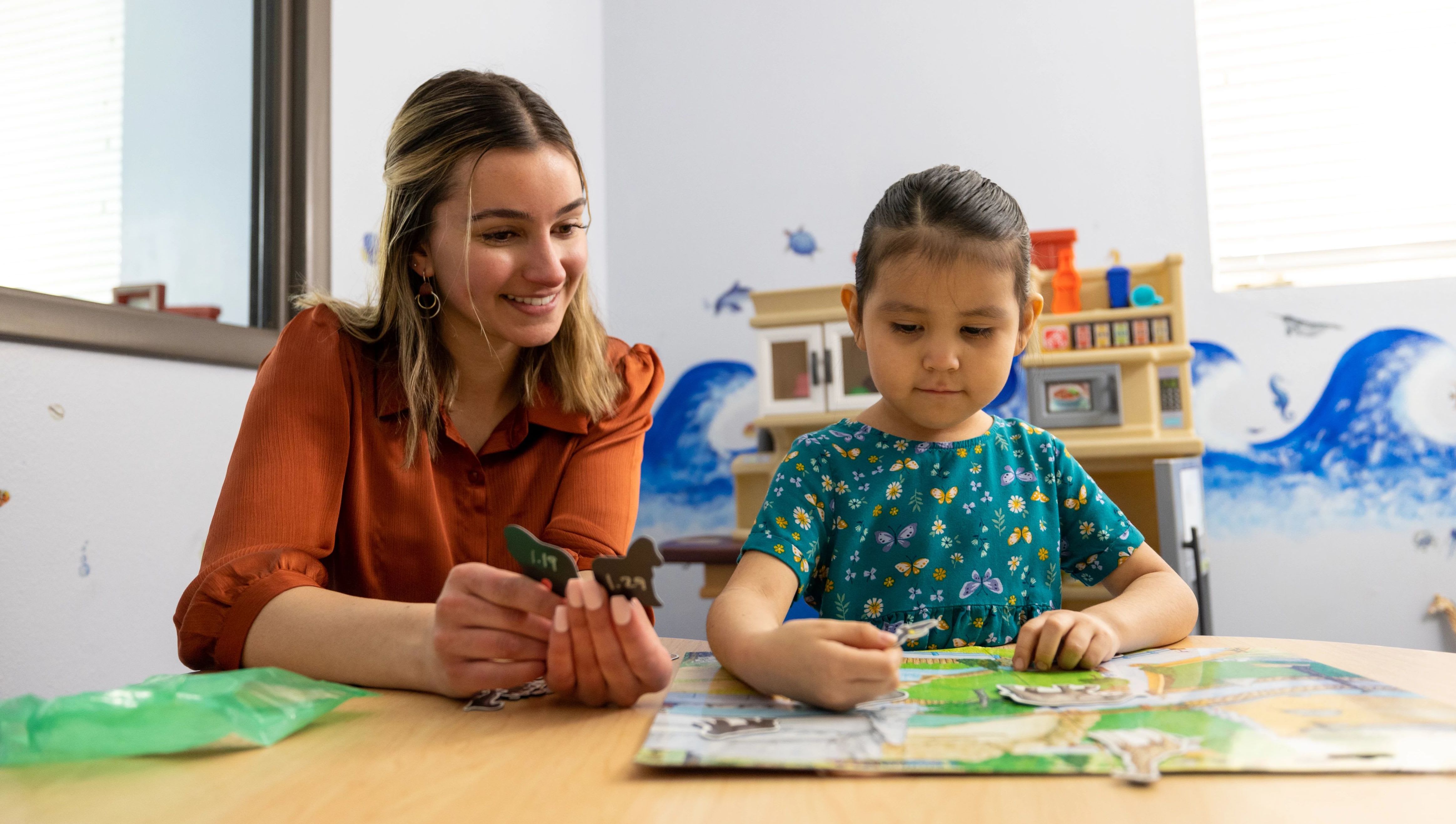 Speech-language pathology student working with a young girl.