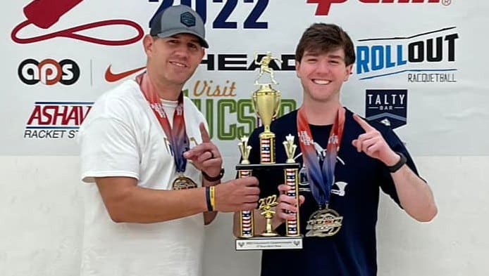 Racquetball members posing with trophy