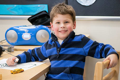 A child colors at the LAB Preschool at the University of Montana.