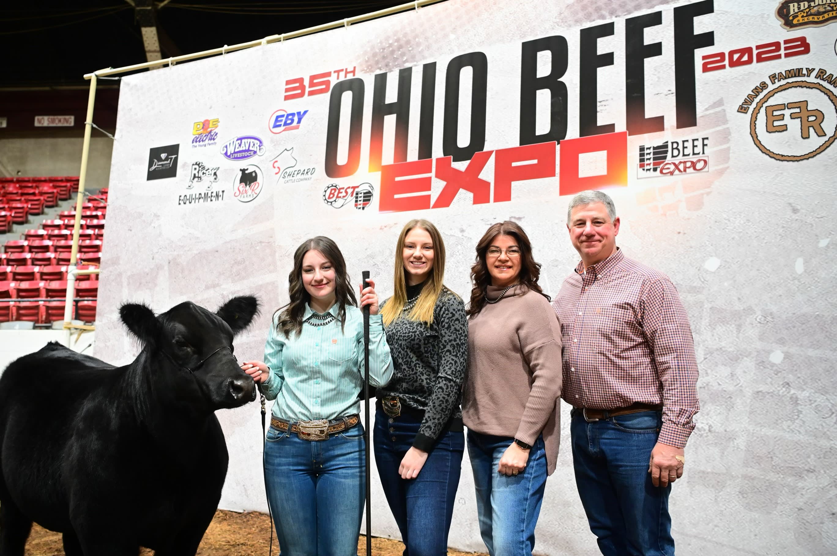 Four members of the Bok family standing with a steer at the Ohio Beef Expo