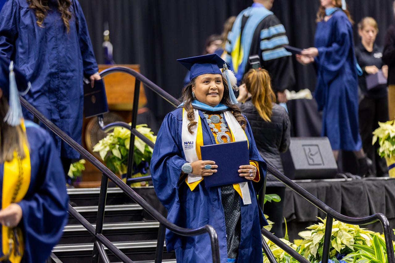 A person in a graduation gown

AI-generated content may be incorrect.