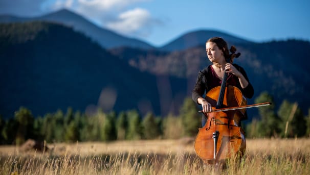 Cello student playing in field