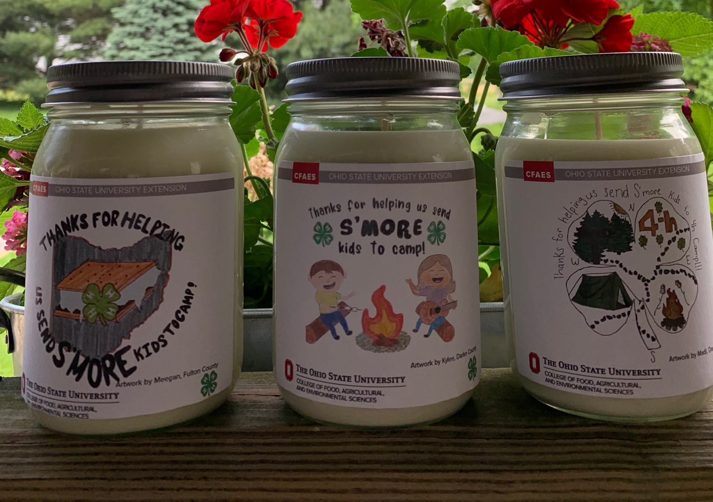 Three candles with labels designed by members of Ohio 4-H.