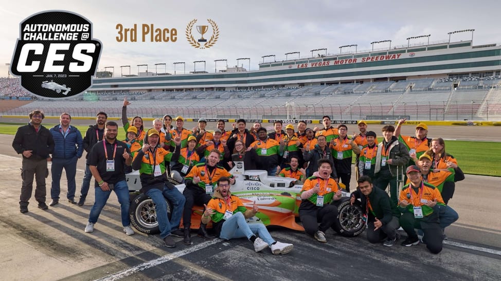 ROAR team gathered around their Autonomous Challenge racecar at the Las Vegas Motor Speedway.