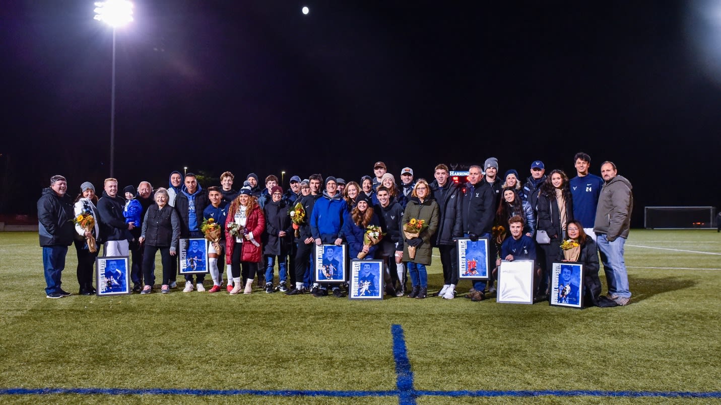 A group of people standing on a field holding awards

Description automatically generated with medium confidence