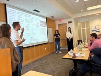 Presenters showcasing the program information to students in a classroom setting 