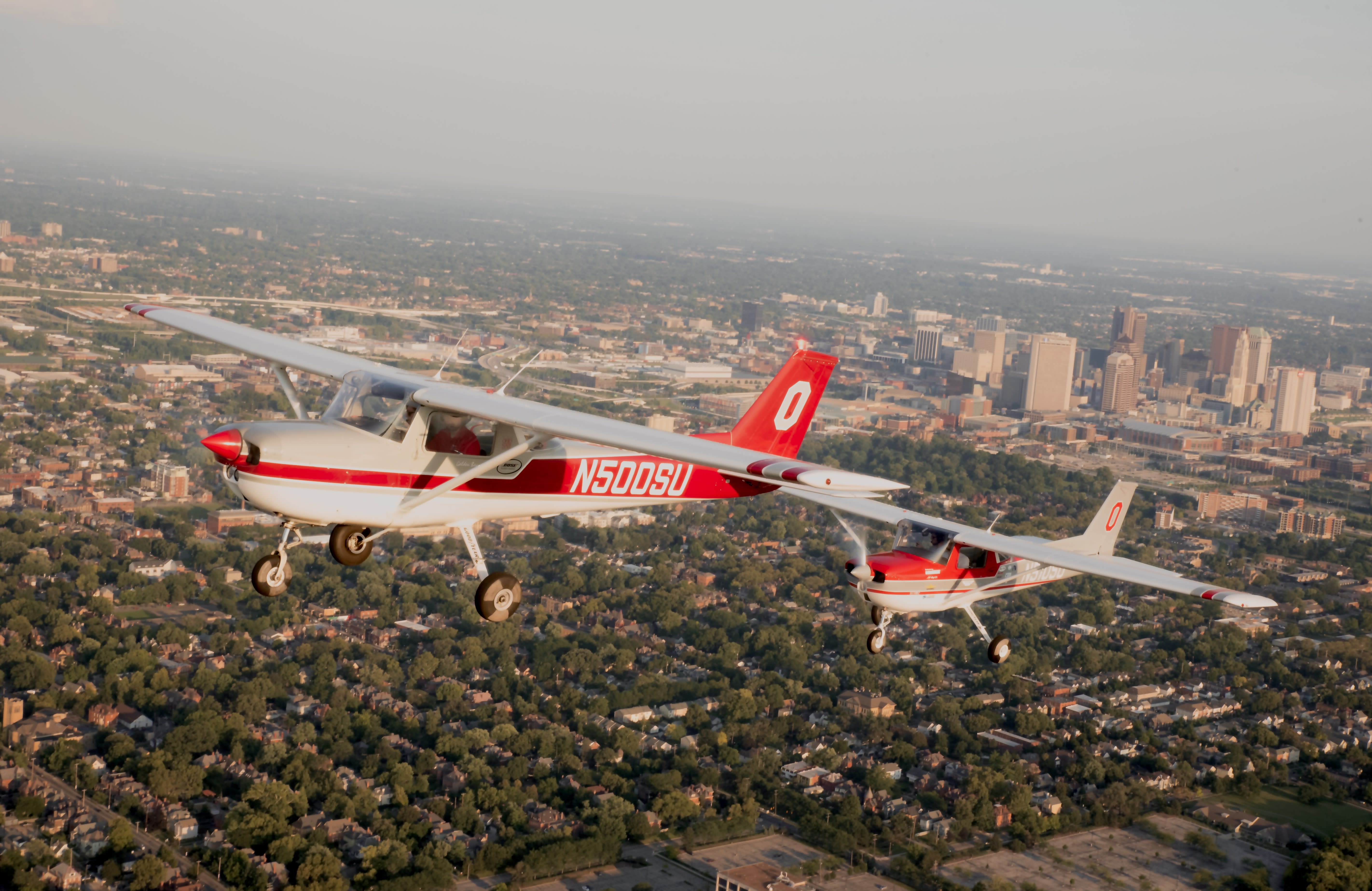 Two Ohio State planes flying over a residential area