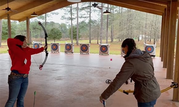 Students shooting bows on archery range