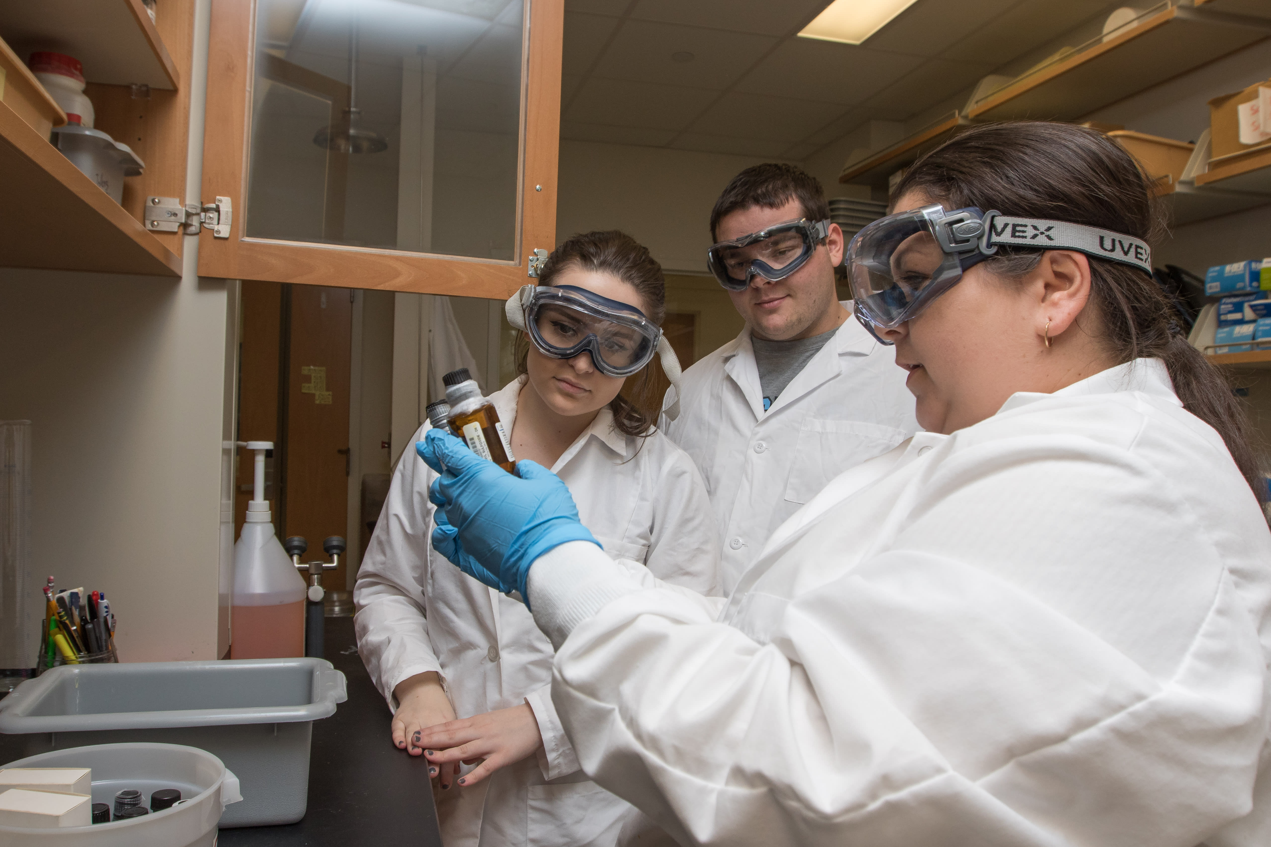 Image of Stockton University professor of chemistry, Dr. Pamela Cohn in research lab with SSEP students Christina Tallone and Daniel Schneider