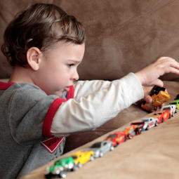 Image of child playing with toy cars