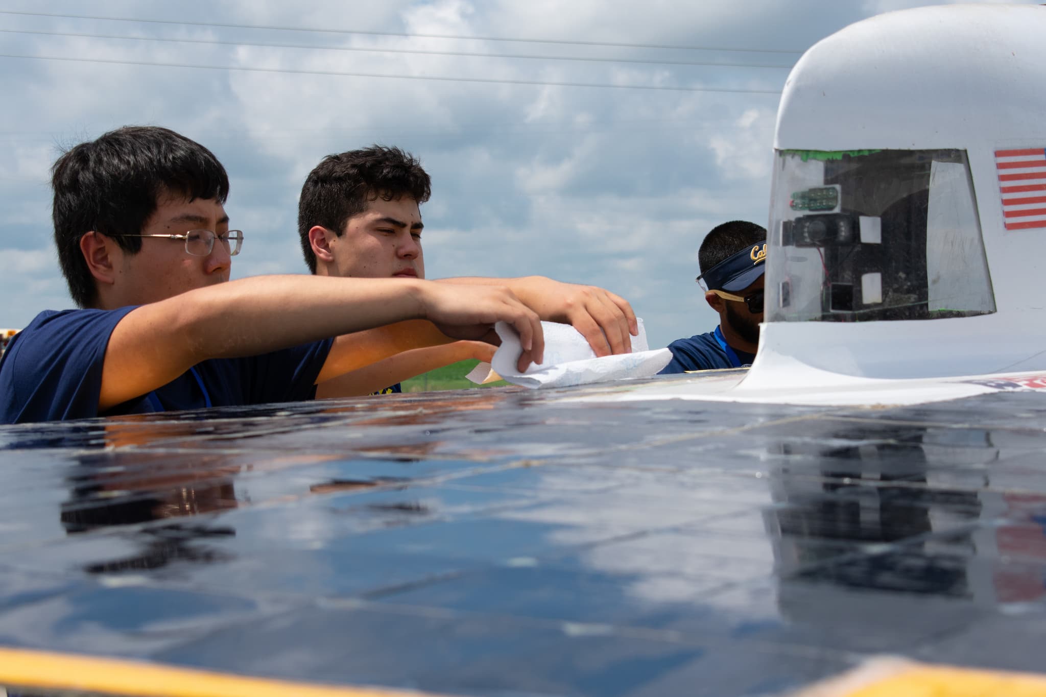 Our members clean dust off the solar array to increase its efficiency.