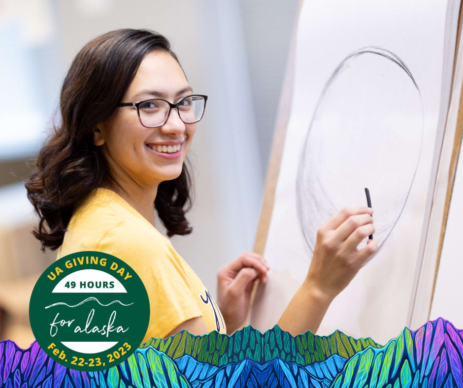 Kaia Richardson, Mat-Su student, drawing in class, and looking at the camera with a big smile!