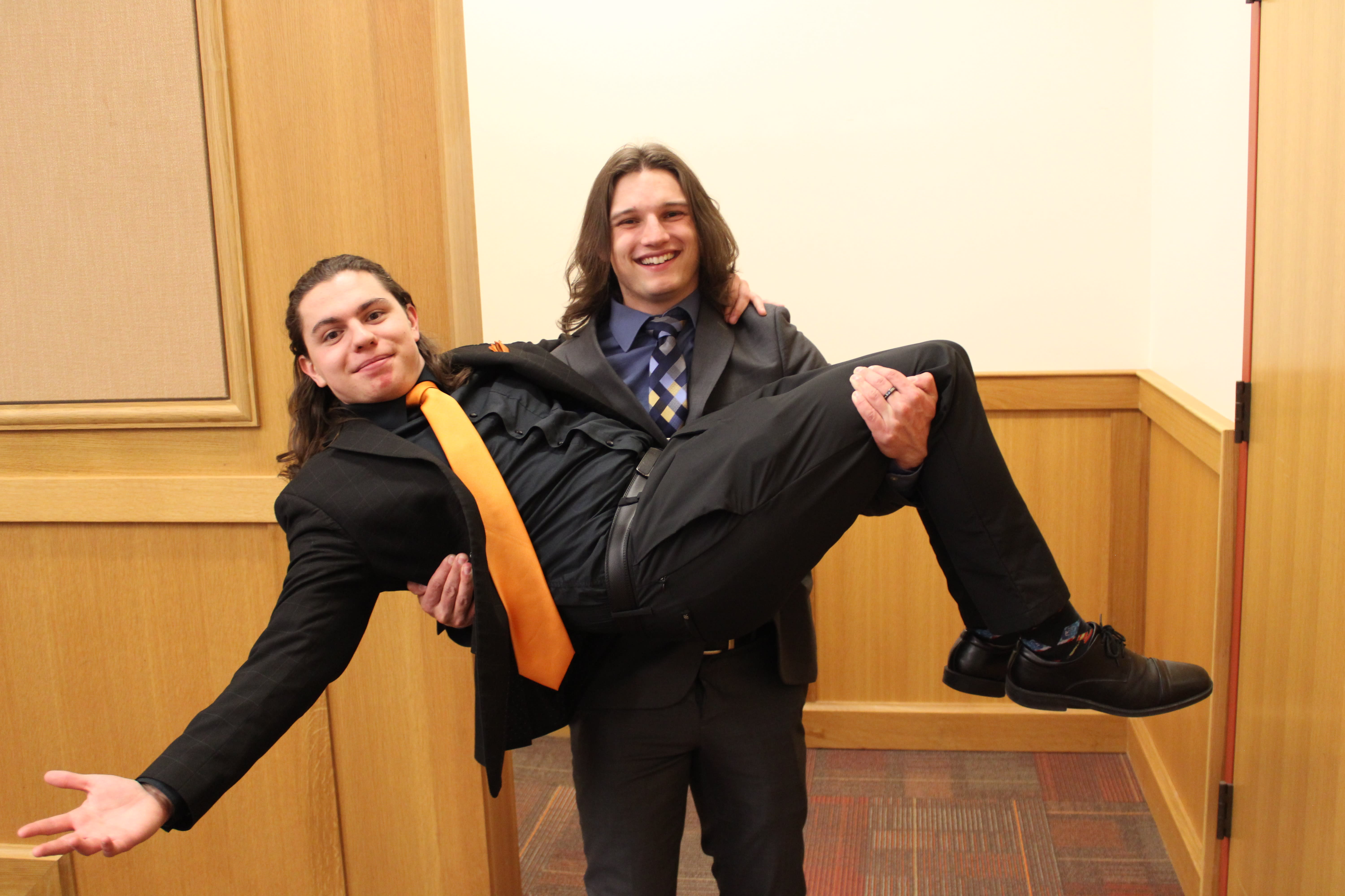 Two Mock Trial members posing for a photo; one holding the other one in his arms