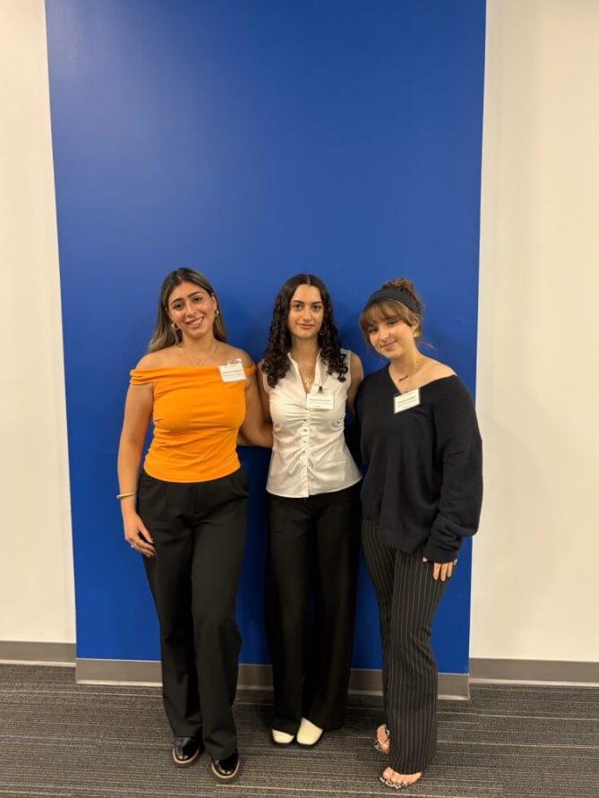 Three students who were awarded scholarships by the Armenian American Alumni Chapter smiling together as they stand side-by-side.