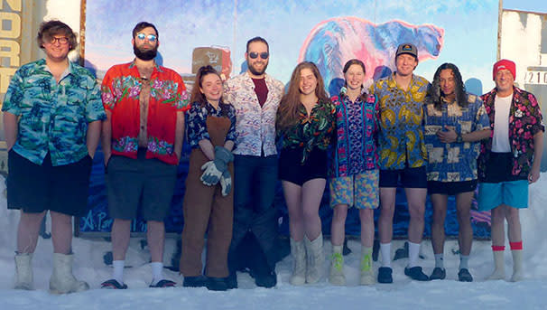 Students standing in arctic wearing hawaiian clothing.wii