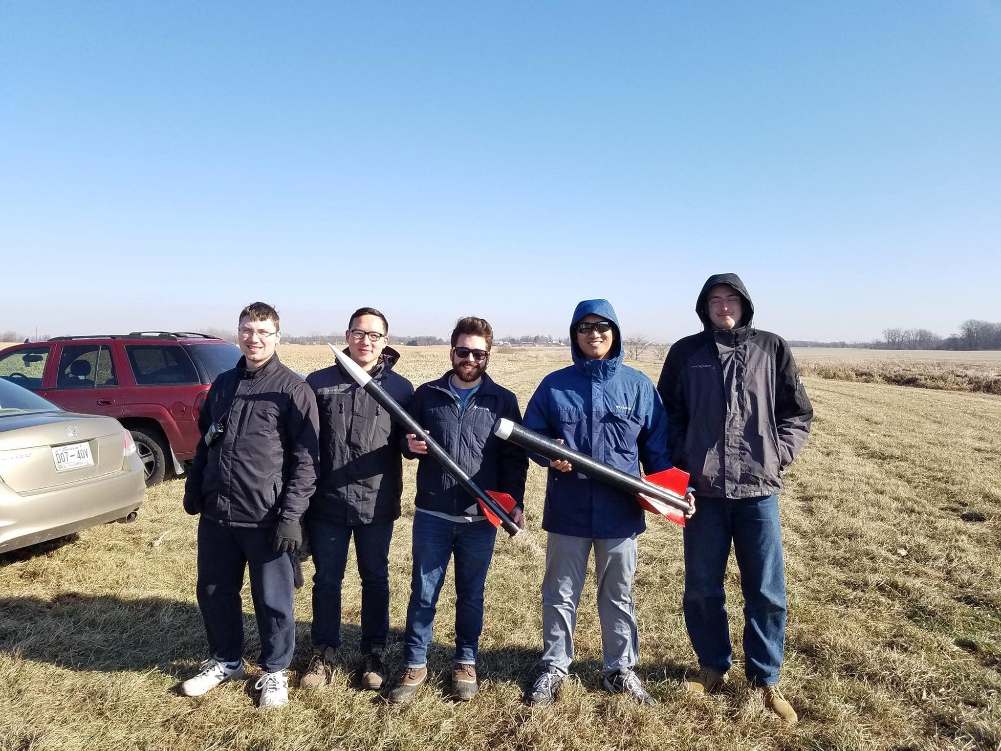 5 students hold parts of launch rockets