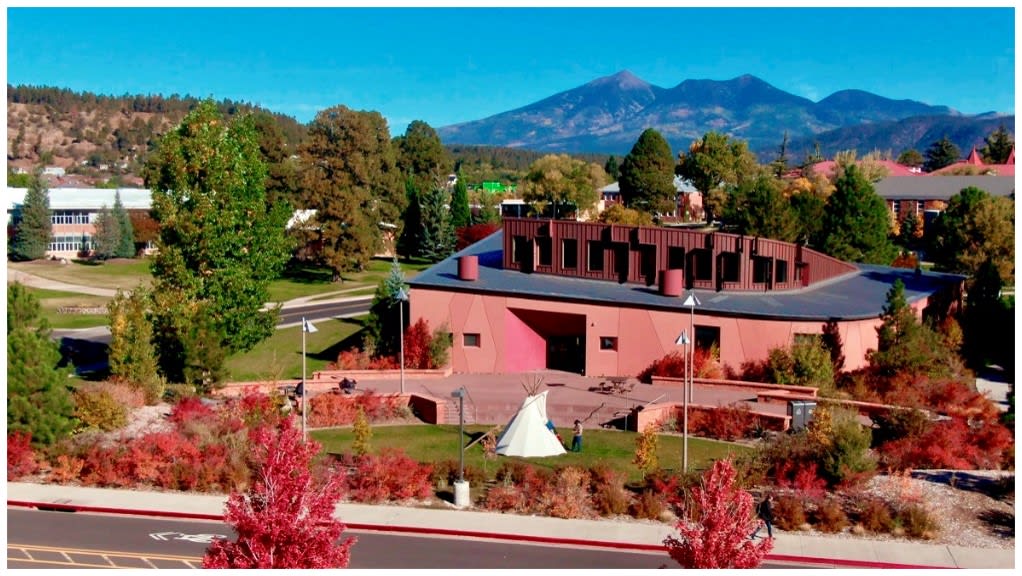 A building with trees and a mountain in the background

AI-generated content may be incorrect.
