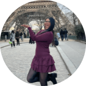 UCI student Samantha Lopez poses in front of the Eiffel Tower during her study abroad program.