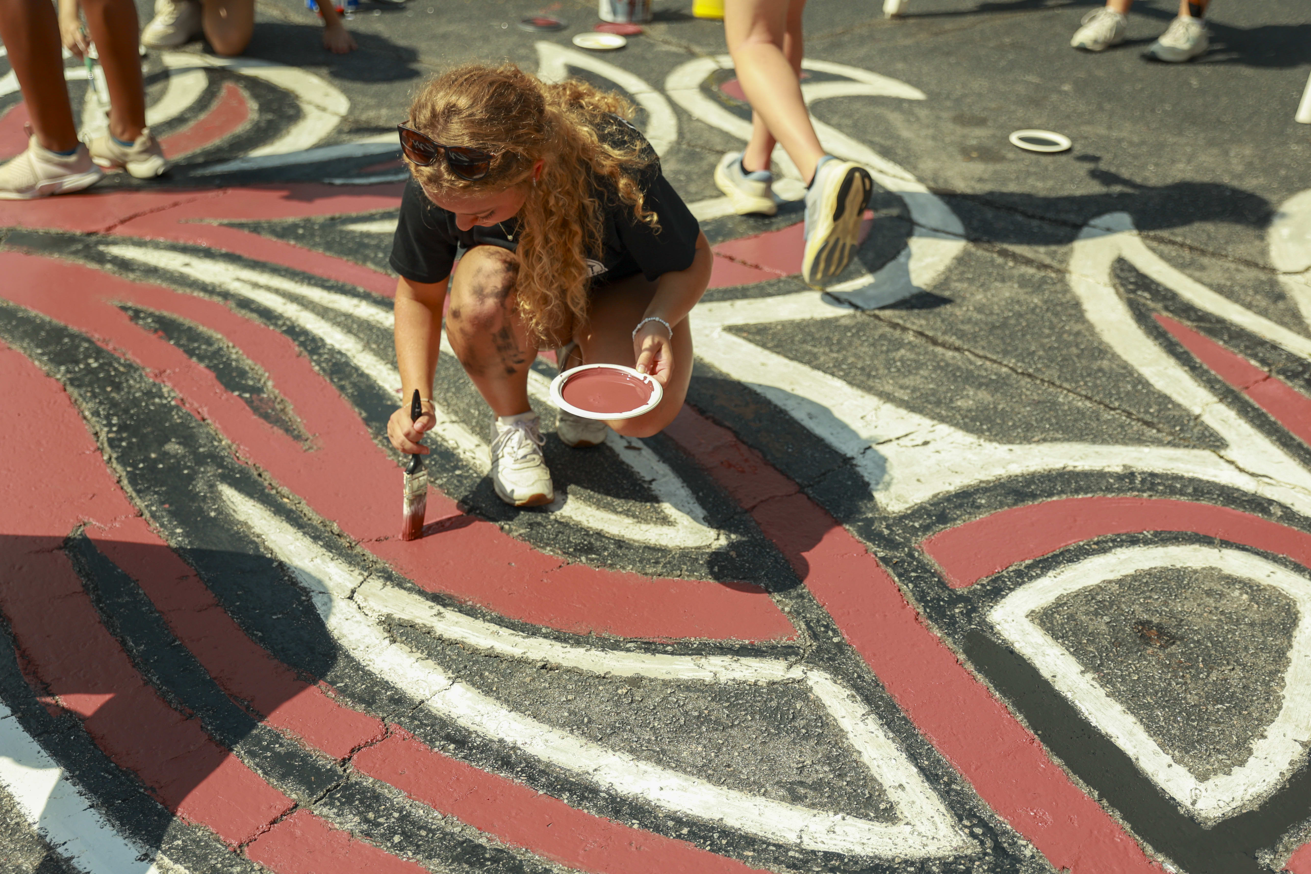 Photo of student painting Gamecock logo