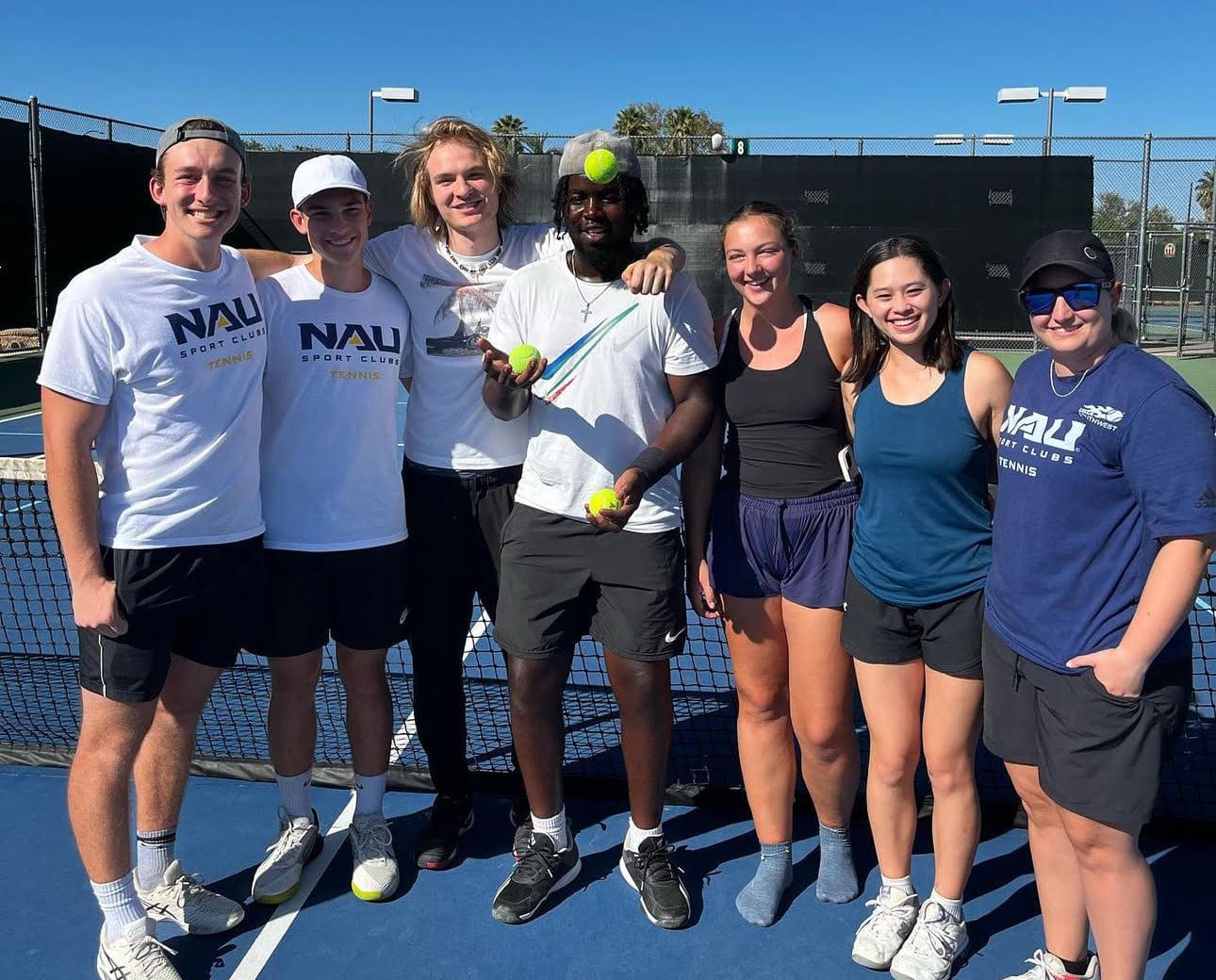 Tennis players posing for group shot