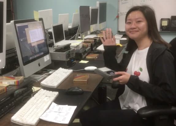 Student worker digitizing a betamax tape.
