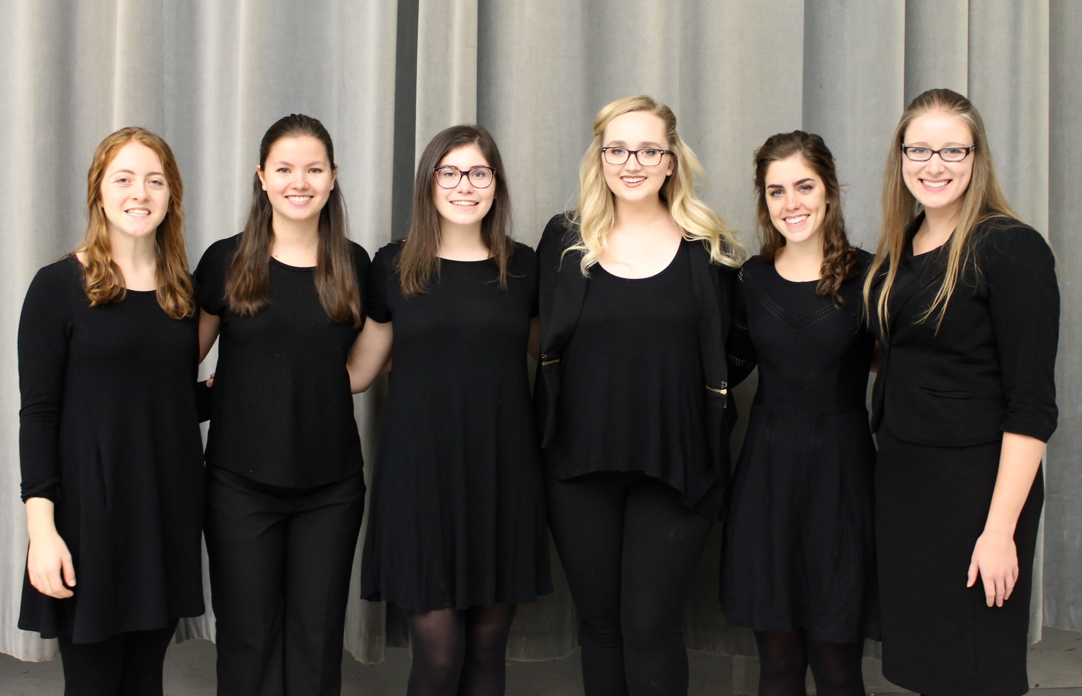 Six individuals on the Women's Glee Club 2017-2018 Executive Officer Team standing together for a group photo