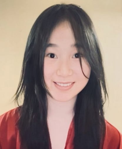 A person with long black hair

Description automatically generated