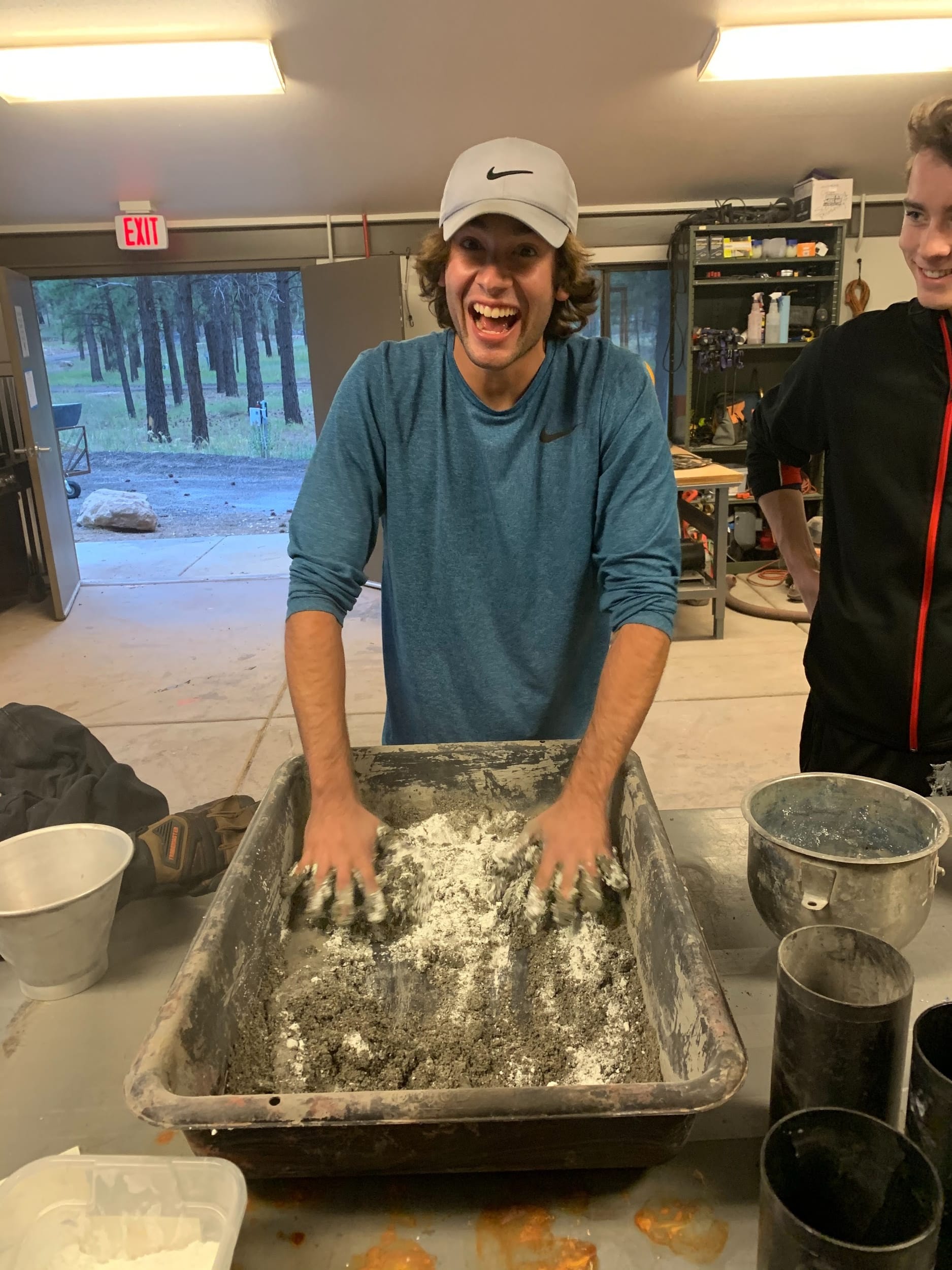 Kyle mixing concrete with his hands 