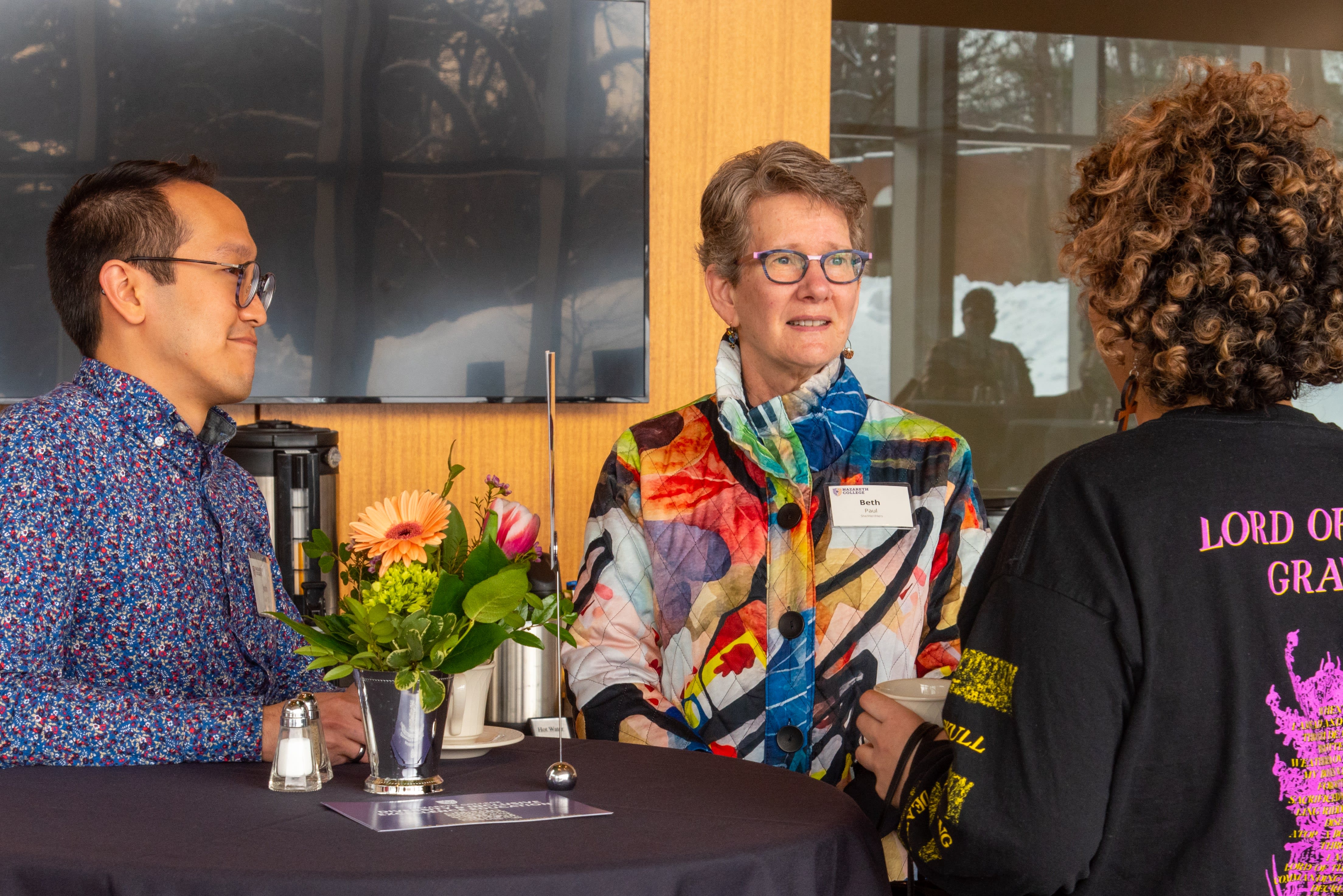 President Beth Paul talking with alumna