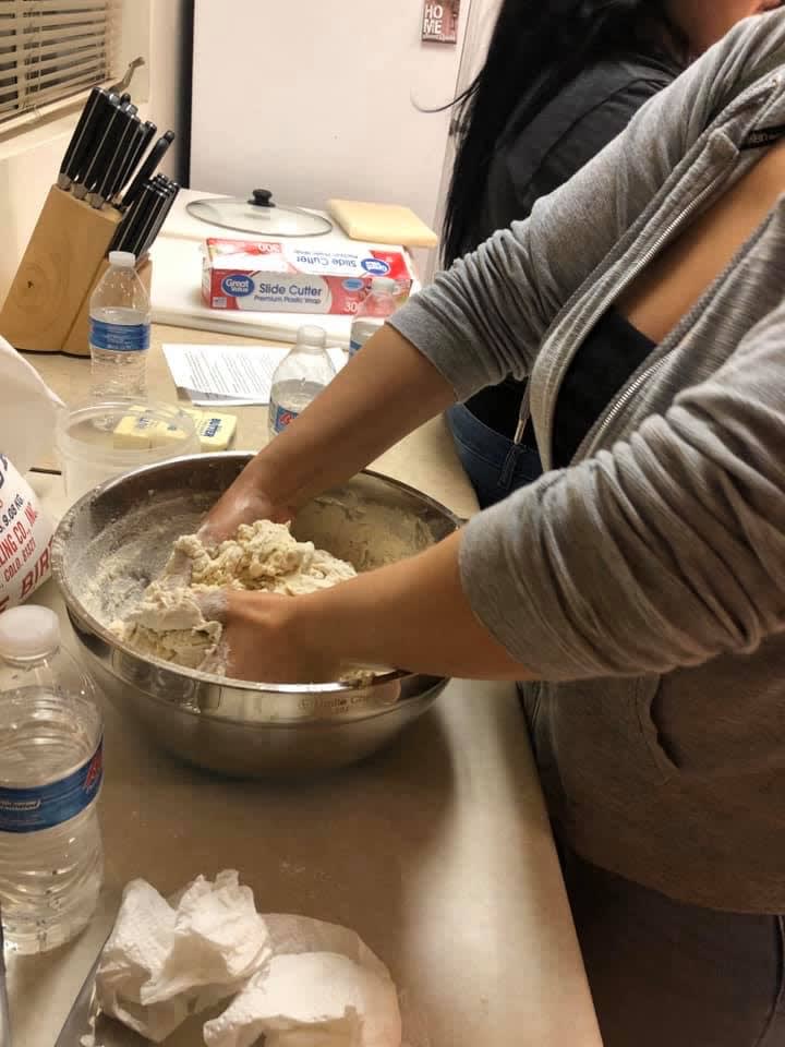 Foster Arizona Housing Project participants learning meal preparation skills through active engagement