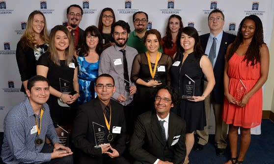 Students and professor holding awards