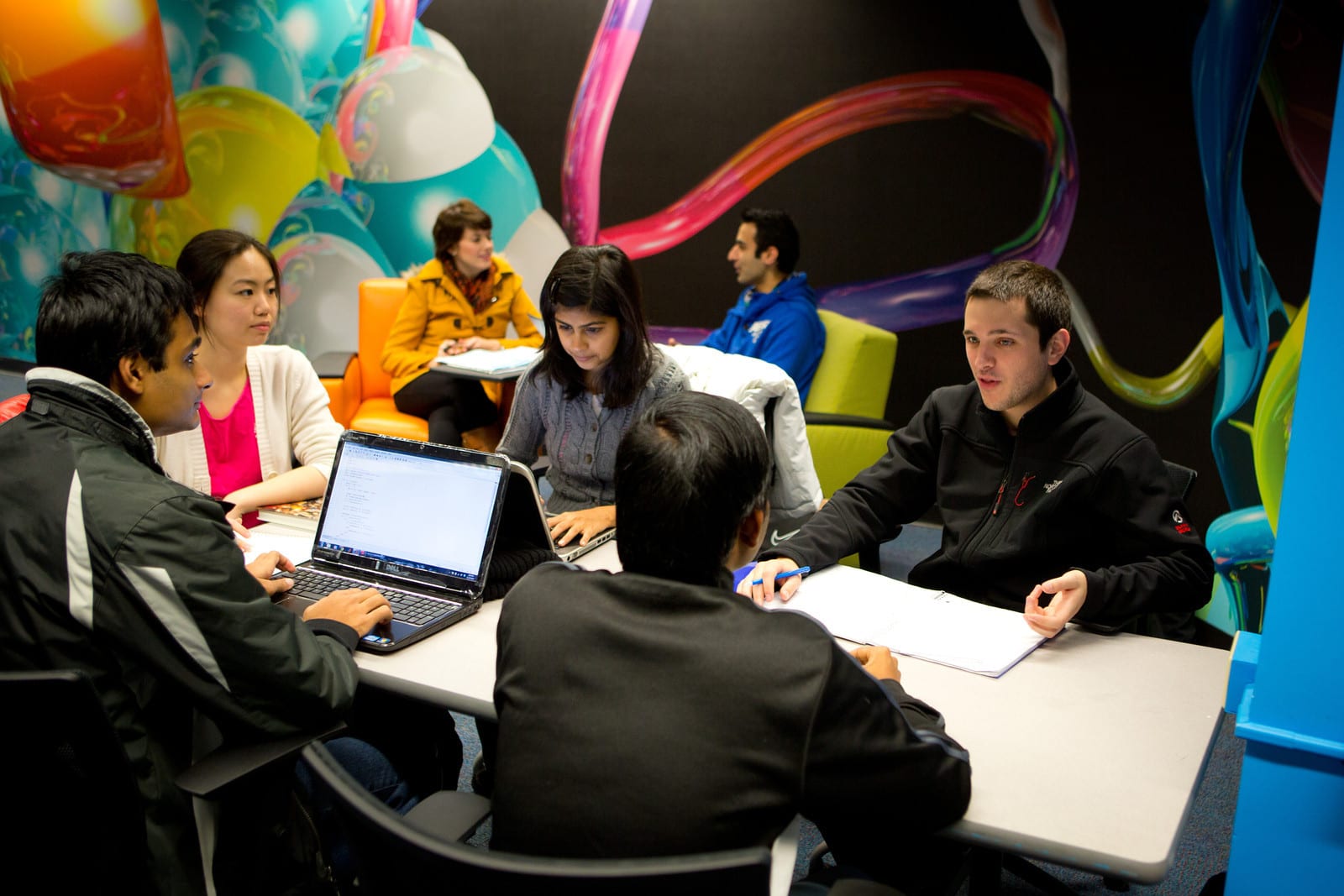 International students working on a project in the International Student Services Center.